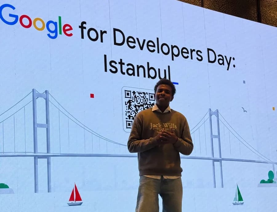 Ahmed Eltigani on stage in front of a Google for Developers Day: Istanbul screen showing the Bosphorus Bridge